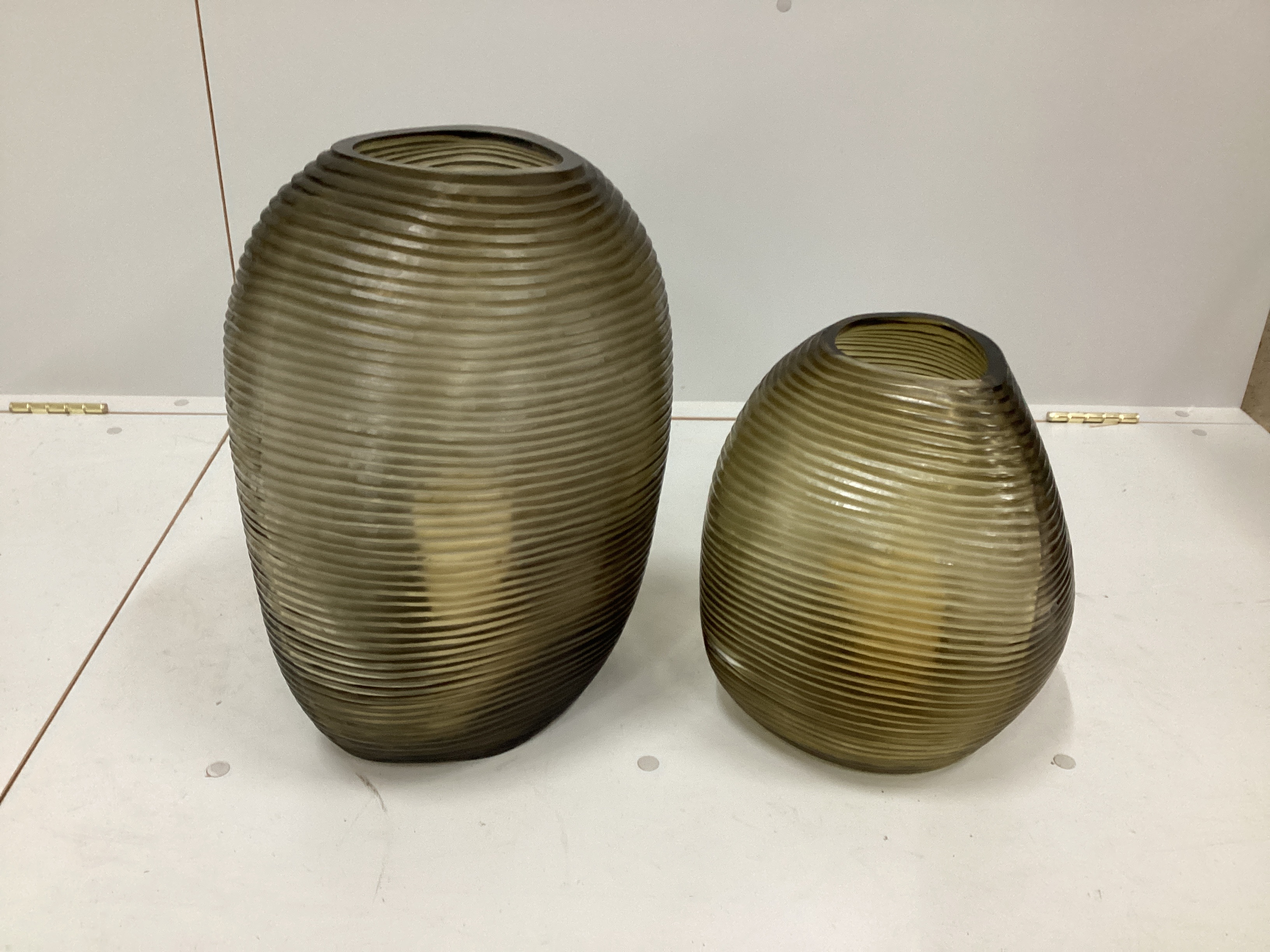Two contemporary “Guaxs” amber glass vases of ribbed irregular form, larger height 42cm
